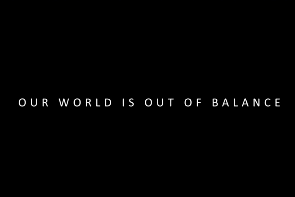 A slide during a video presentation warns that the world is out of balance.