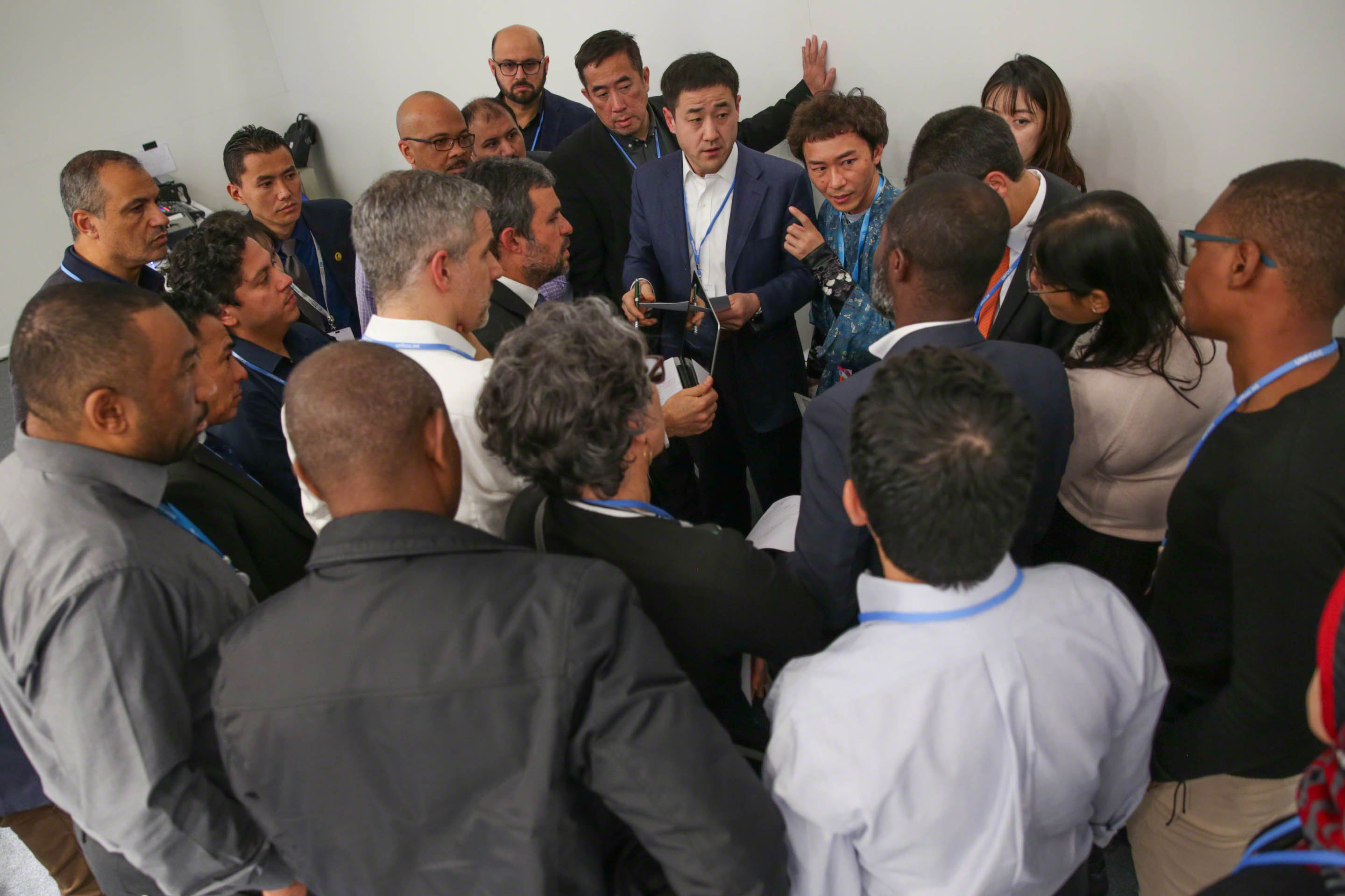 As the first week of COP 25 draws to a close, members of the G-77/China huddle during an informal consultation to try reach agreement.