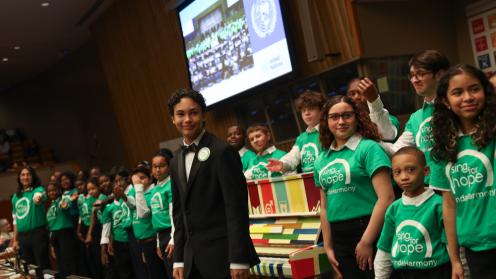 Children from 'Sing for Hope' perform a song during the closing, played on the SDG piano