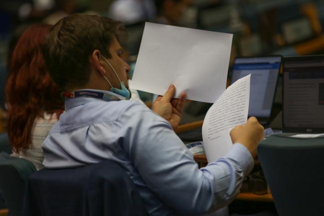 Delegates review a resolution under discussion