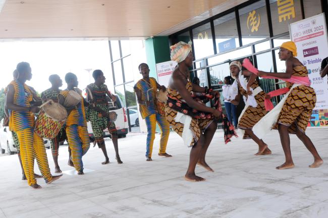 Dancers greet delegates at the entrance of the venue