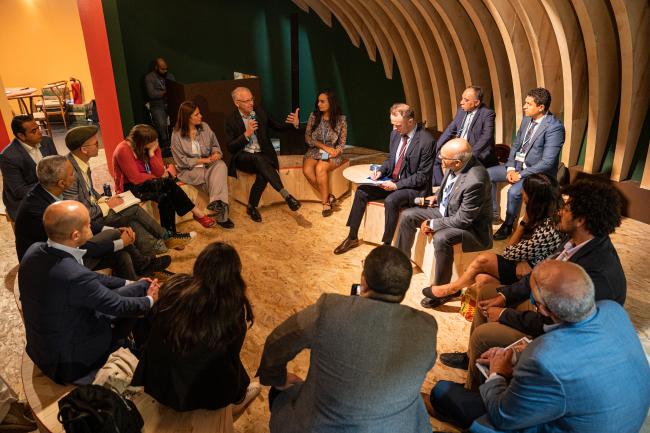 A panel discusses climate-smart crops with participants