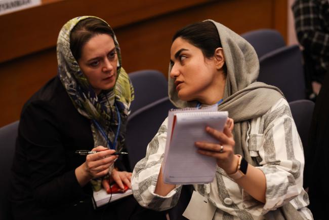 Participants confer during the meeting_OEWG1.2_30jan2023_photo.jpg