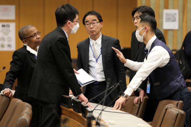 Delegates conferring during a break in negotiations