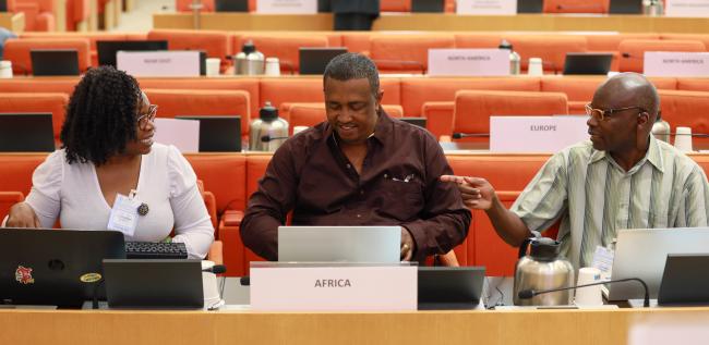 Delegates from Africa conferring before the morning session