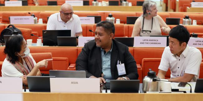 Delegates from Asia conferring before the morning session