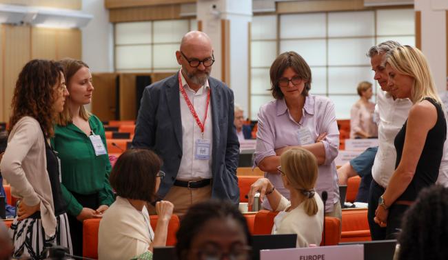 Delegates from Europe conferring during a break in negotiations