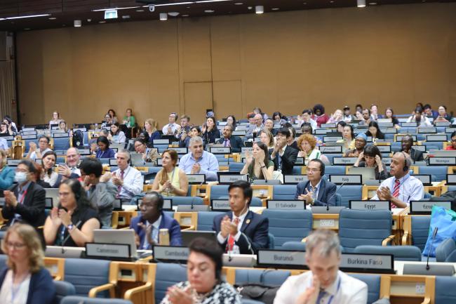 Delegates applaud the closing of the meeting