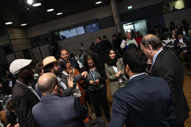 Delegates consult informally before the beginning of plenary