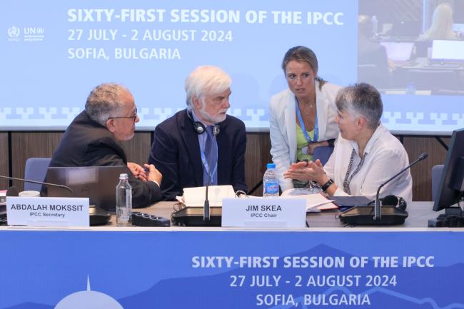 IPCC Secretary Abdalah Mokssit and IPCC Chair Jim Skea consult with Brittany Croll, United States, and Debra Roberts, South Africa  IPCC Secretary Abdalah Mokssit and IPCC Chair Jim Skea consult with Brittany Croll, United States, and Debra Roberts, South Africa