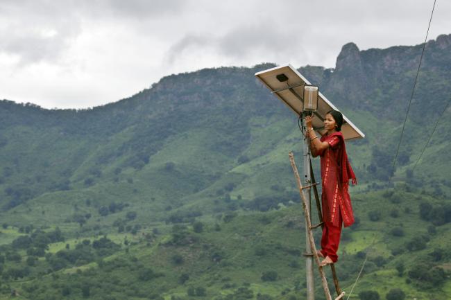 Lady setting solar panel