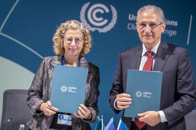 Inger Andersen, Executive Director, UN Environment Programme (UNEP) and Mukhtar Babayev, COP29 President, hold their signed Letters of Intent for the Baku Dialogue on Water for Climate Action 