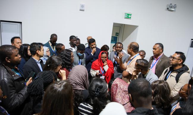 Delegates in a huddle in the corridors