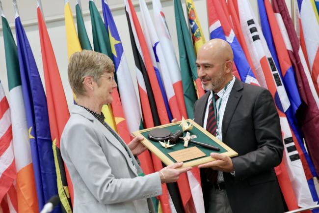 ITTC-61 incoming Chair Carlos Espinosa Peña (Panama) presents a framed gavel to outgoing ITTC-60 Chair Anna Tyler (New Zealand).